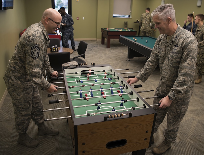 U.S. Air Force Chief Master Sgt. James E. Fitch, 87th Air Base Wing command chief, and U.S. Air Force Col. David LeRoy, 305th Air Mobility Wing vice commander, play foosball during a ribbon cutting ceremony for the reopening of the Flight Deck on Joint Base McGuire-Dix-Lakehurst, New Jersey, Nov. 1, 2018. The Flight Deck underwent renovations and now offers Joint Base MDL community members multiple recreational activities. (U.S. Air Force photo by Airman 1st Class Ariel Owings)