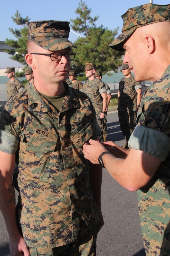 CAMP HUMPHREYS, Republic of Korea – Maj. Gen. Patrick J. Hermesmann (right), commander of U.S. Marine Corps Forces Korea, awards Gunnery Sgt. Roger Reyes, MARFORK G-4 ammunition chief, a Good Conduct Medal here, Nov. 1. MARFORK awarded Reyes the medal for demonstrating character expected of a Marine within the highest standards of Marine Corps ethos. (U.S. Marine Corps photo by Staff Sgt. Anthony Kirby/Released)