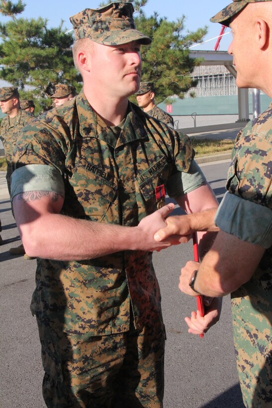 CAMP HUMPHREYS, Republic of Korea – Maj. Gen. Patrick J. Hermesmann (right), commander of U.S. Marine Corps Forces Korea, awards Sgt. Nathaniel Hatfield, MARFORK G-4 embarkation specialist, a Good Conduct Medal here, Nov. 1. MARFORK awarded Hatfield the medal for demonstrating character expected of a Marine within the highest standards of Marine Corps ethos. (U.S. Marine Corps photo by Staff Sgt. Anthony Kirby/Released)