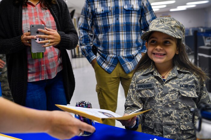 Cheyenne Arredondo, a youth center member, takes her deployment package, Nov. 3, 2018, at Joint Base Charleston, S.C.