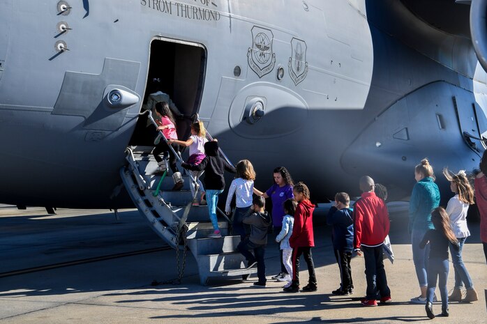 Kids climb on to a C-17 Globemaster III during a mock deployment, Nov. 3, 2018, at Joint Base Charleston, S.C.