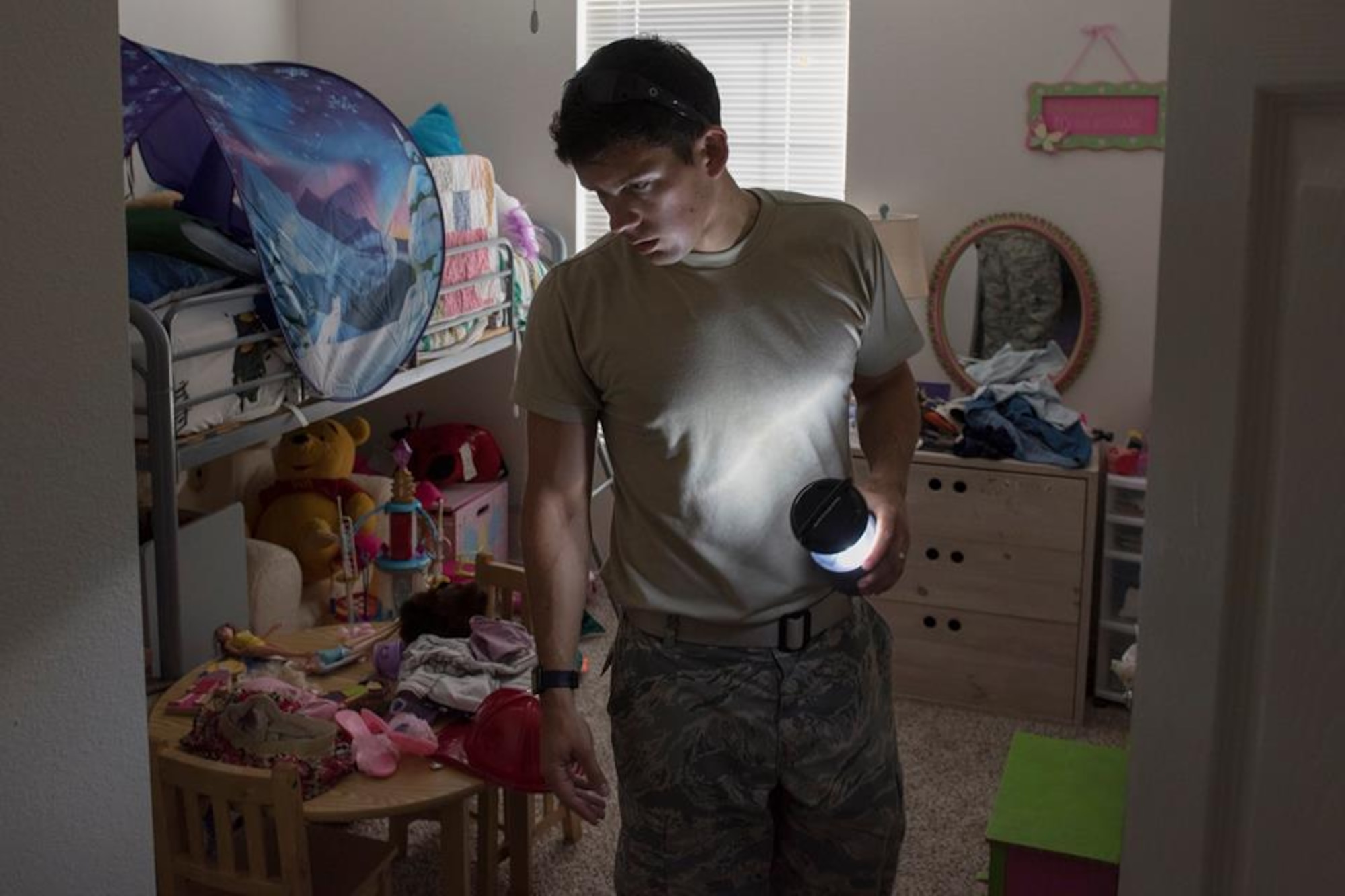 1st Lt. Adam Kriete, 337th Air Control Squadron student, searches for clothing items in his daughters room that was affected Hurricane Michael, at Tyndall Air Force Base, Oct. 19, 2018. Tyndall AFB was damaged by Hurricane Michael which displaced approximately 11,000 people, to include the Kriete family who travelled back to Tyndall during a five hour window to recover their belongings.