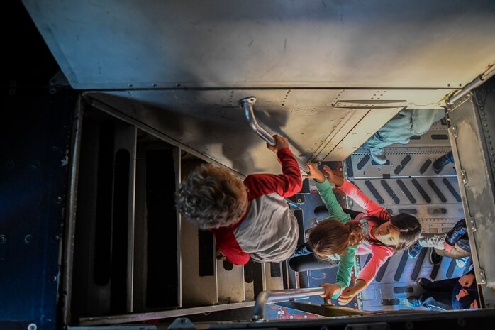Kids climb into the cockpit of a C-17 Globemaster III during a mock deployment, Nov. 3, 2018, at Joint Base Charleston, S.C.