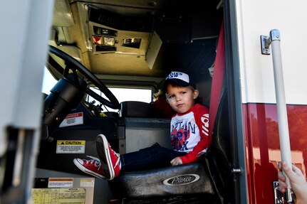 A child sits in a fire truck, Nov. 3, 2018, at Joint Base Charleston, S.C.
