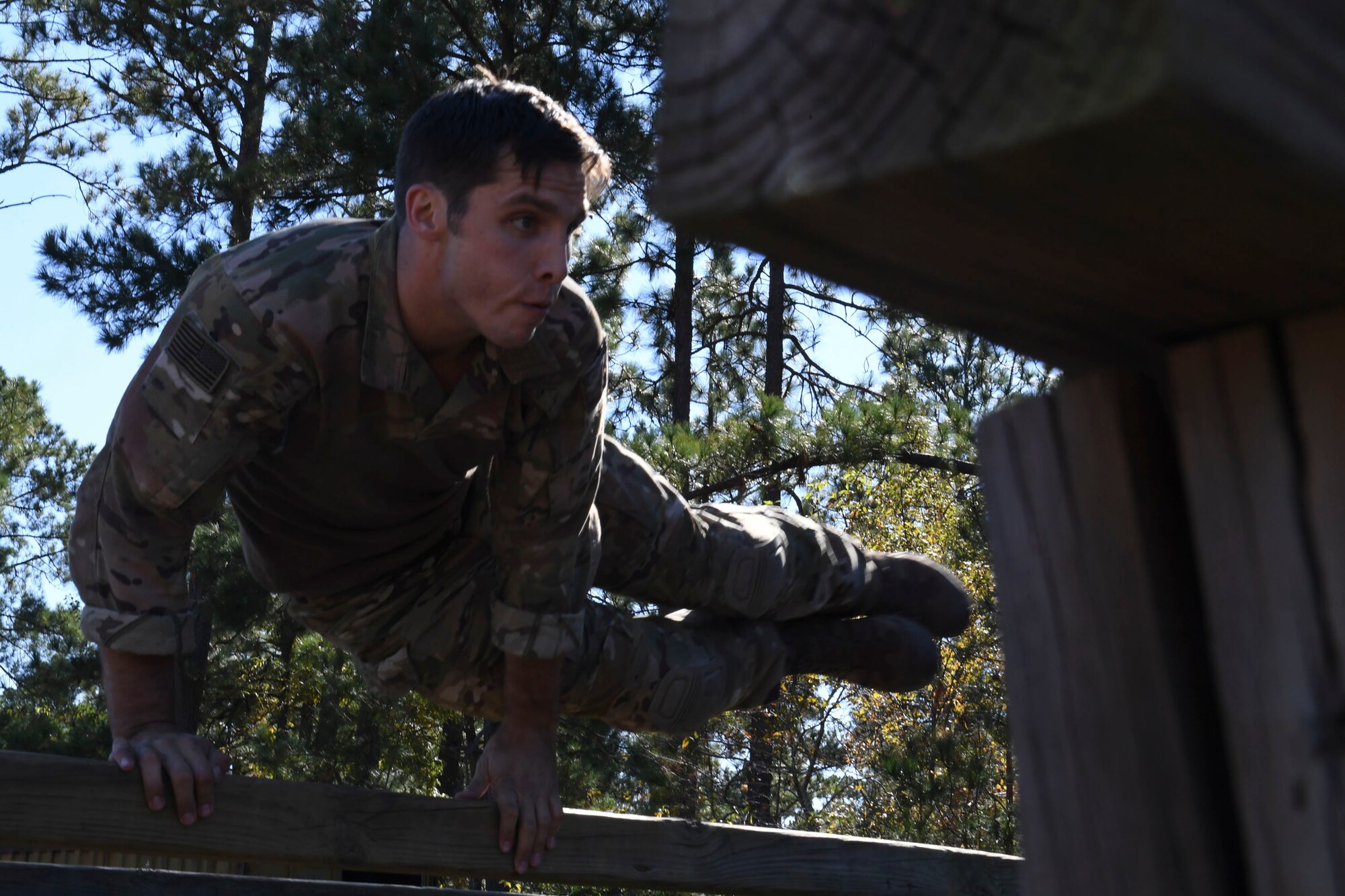 U.S. Air Force Staff Sgt. Benjamin Blake, a competitor from the 20th Air Support Operations Squadron, jumps over an obstacle during the Dragon Challenge 2018 at Fort Bragg, North Carolina Oct. 31, 2018. After the obstacle course, Dragon Challenge competitors took an Army knowledge test to see how well they understand the sister service they support. (U.S. Air Force photo by 1st Lt. Faith Brodkorb)