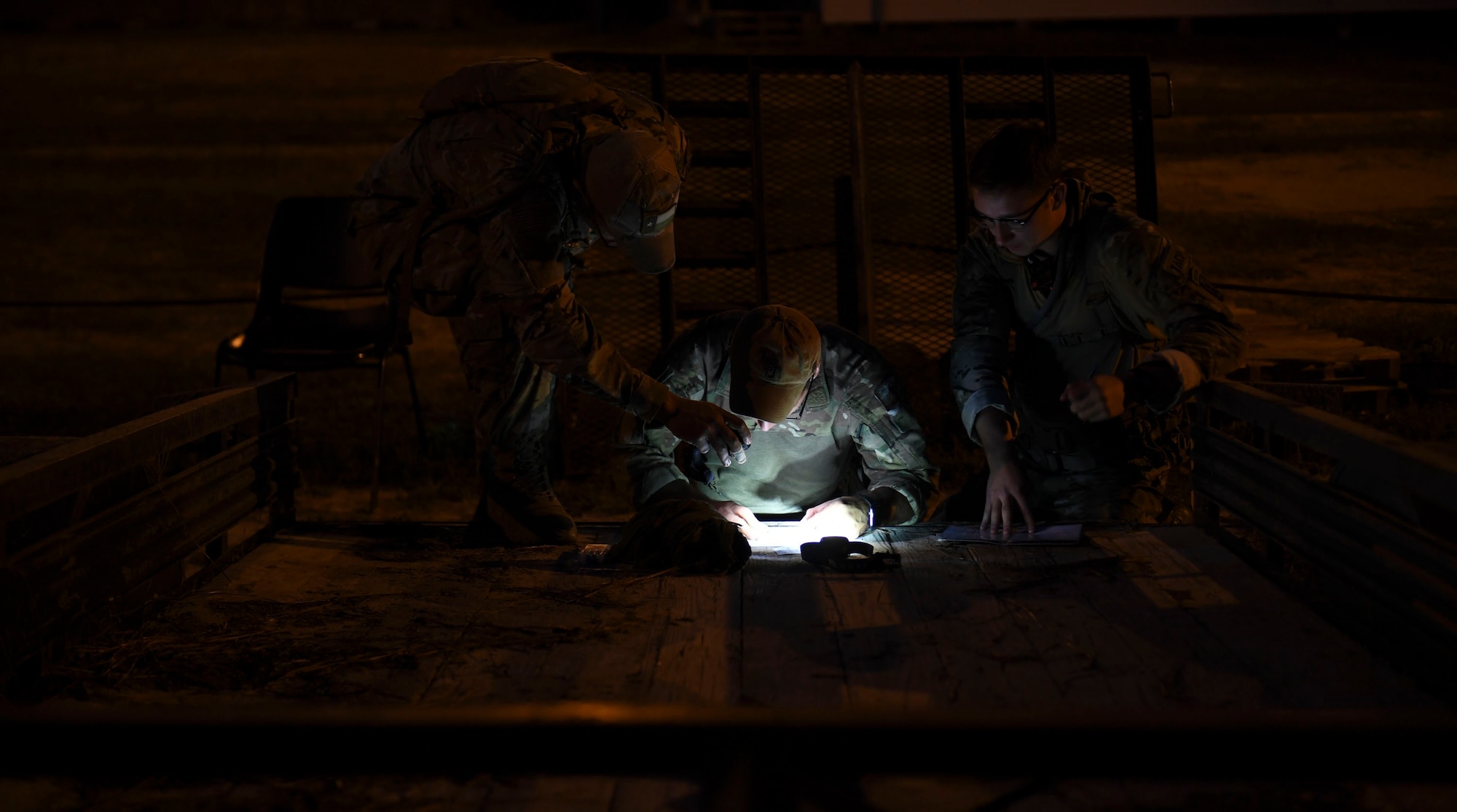 Competitors from the 20th Air Support Operations Squadron plan their route during the night land navigation event of Dragon Challenge 2018 at Fort Bragg, North Carolina Oct. 31, 2018. The event required competitors to navigate through the woods in the dark to as many points as possible within the allotted time. (U.S. Air Force photo by 1st Lt. Faith Brodkorb)