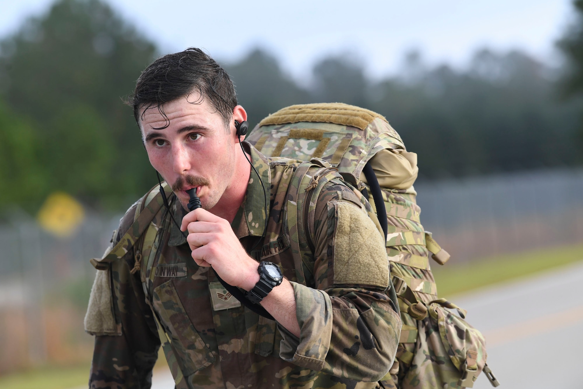Senior Airman Aaron Conway from the 14th Air Support Operations Squadron sips water during the ruck march in the Dragon Challenge 2018 at Fort Bragg, North Carolina, Nov. 1, 2018. Dragon Challenge competitors had four hours to complete the 12-mile ruck march. The ruck march was one of the 11 events during the challenge. (U.S. Air Force photo by 1st Lt. Faith Brodkorb)