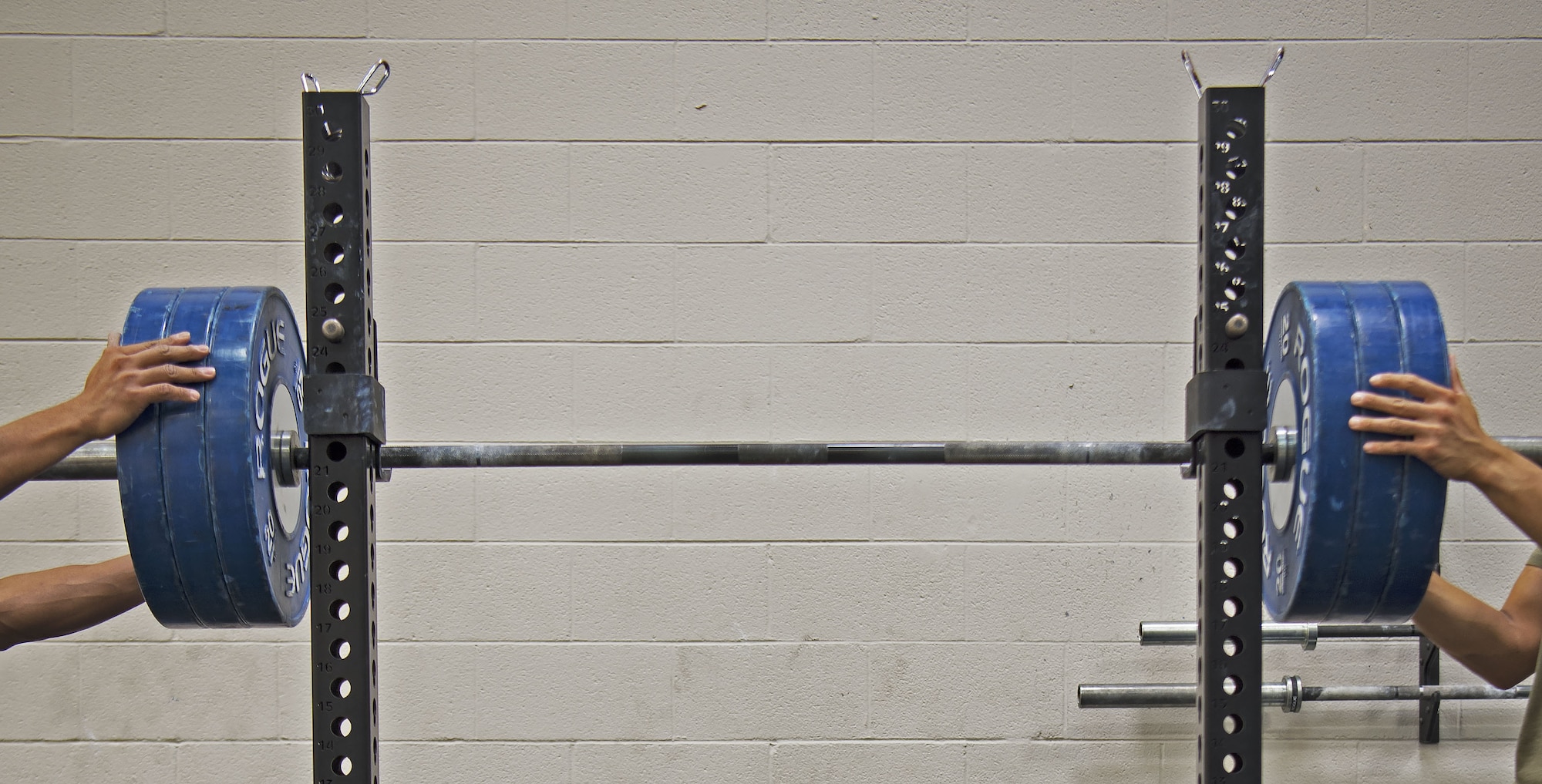 Clayton Bautista, Five Star Nutrition general manager, left, helps Staff Sgt. Allen Plata, 20th Equipment Maintenance Squadron stockpile management crew chief, rack weights off a barbell at Shaw Air Force Base, S.C., Nov. 1, 2018.