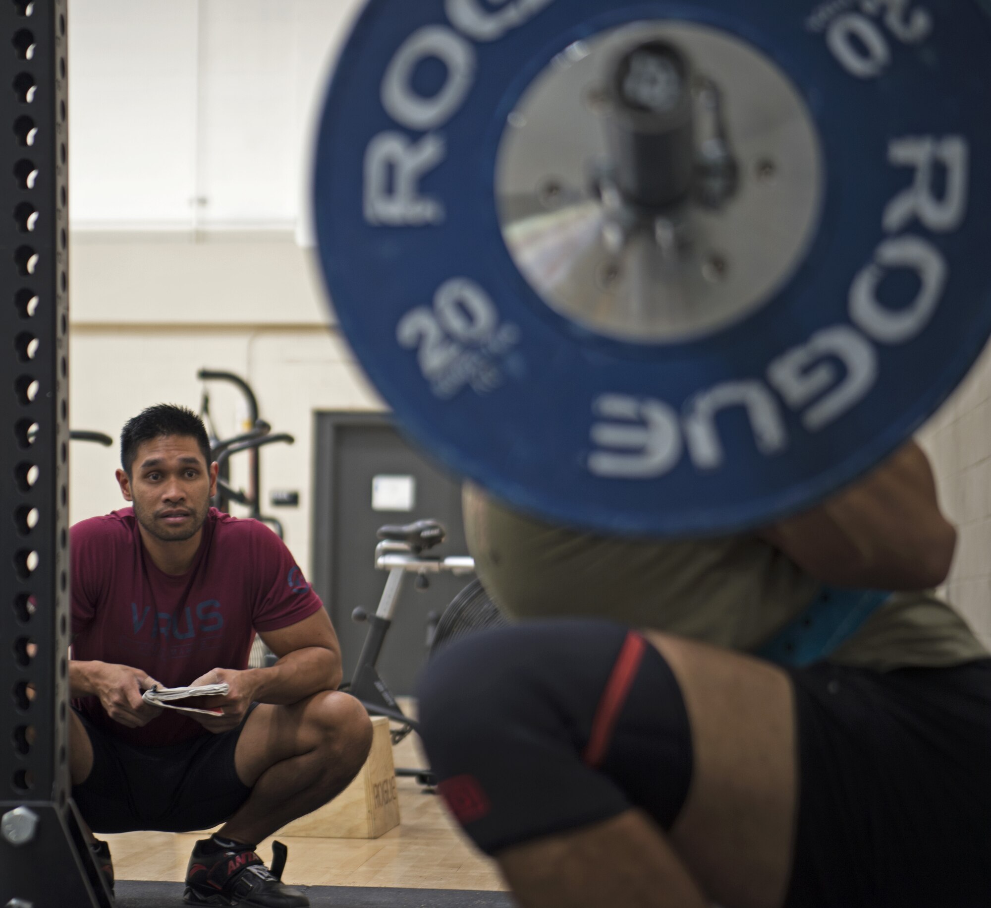 Clayton Bautista, Five Star Nutrition general manager, left, ensures Staff Sgt. Allen Plata, 20th Equipment Maintenance Squadron stockpile management crew chief, has proper form while power lifting at Shaw Air Force Base, S.C., Nov. 1, 2018.