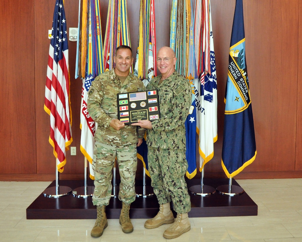Chilean Navy Col. Jorge Keitel, Partner Nation Liaison Officer (PNLO) assigned to U.S. Southern Command (SOUTHCOM), presents plaque of appreciation to Adm. Kurt Tidd