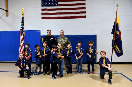 Sgt. David Lietz, public affairs sergeant with the 85th Support Command, pauses for a photo with Officer Joel Detloff, from the Glenview Police Department and students from Lyon Elementary School during the school’s Veteran’s Day observance in Glenview, Illinois, November 5, 2018.