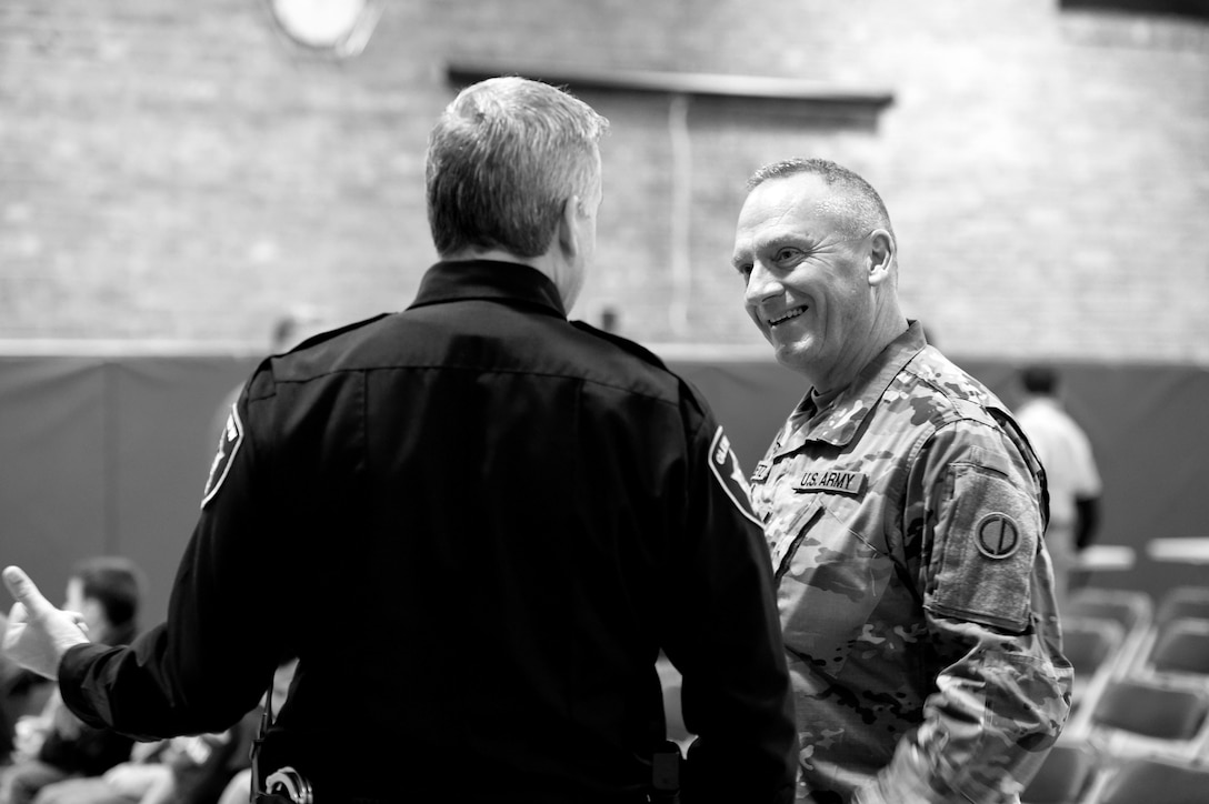 Sgt. David Lietz, right, public affairs sergeant with the 85th Support Command, speaks Officer Joel Detloff, from the Glenview Police Department, during the Lyon Elementary School Veteran’s Day observance in Glenview, Illinois, November 5, 2018.