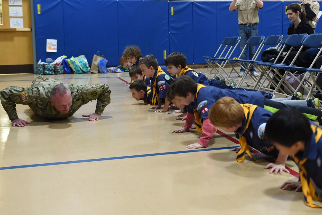 Sgt. David Lietz, public affairs sergeant with the 85th Support Command, shows students how to conduct a push up during the Lyon Elementary School Veteran’s Day observance in Glenview, Illinois, November 5, 2018.