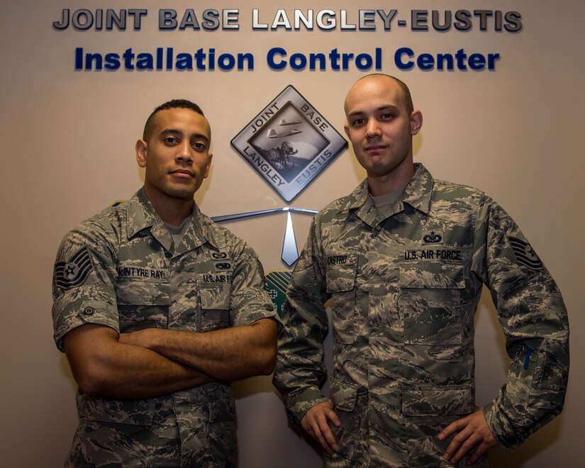 U.S. Air Force Tech. Sgt. Brian McIntyre Ray, 633rd Air Base Wing Command Post NCO in charge of command and control operations, and Tech. Sgt. Zacharie Castro, 633rd ABW Command Post emergency action controller, stand at the installation control center at Joint Base Langley-Eustis, Virginia, Oct. 31, 2018.