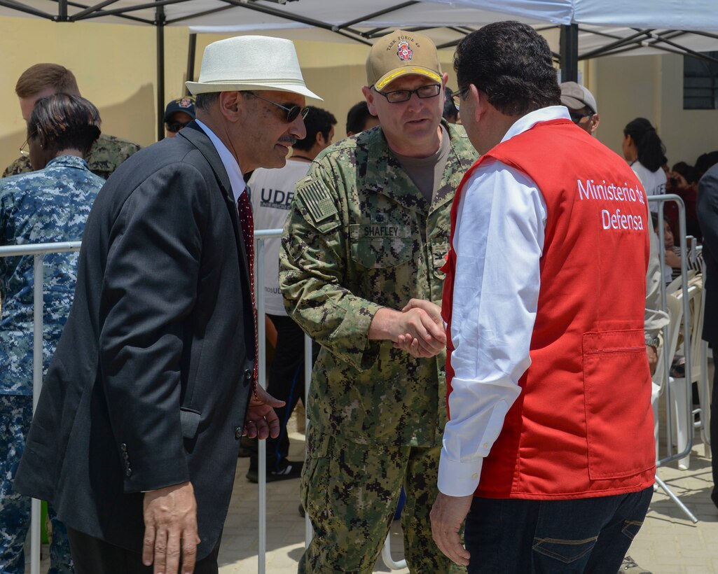 Capt. William Shafley, commander, Task Force 49, meets with Krishna Urs (left), U.S. ambassador to Peru, and Jose Huerta Torres, Peruvian minister of defense, at one of two medical sites.