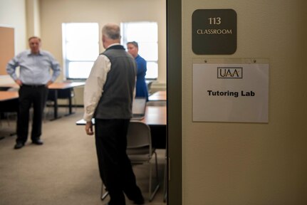 Education service staff prepare for a ribbon-cutting ceremony at the Joint Base Elmendorf-Richardson Education Center Nov. 2, 2018. The ceremony marks the opening of the academic tutoring room sponsored by the University of Alaska Anchorage (UAA). This room is open to all active-duty personnel, dependents and veterans, no matter which school they attend.