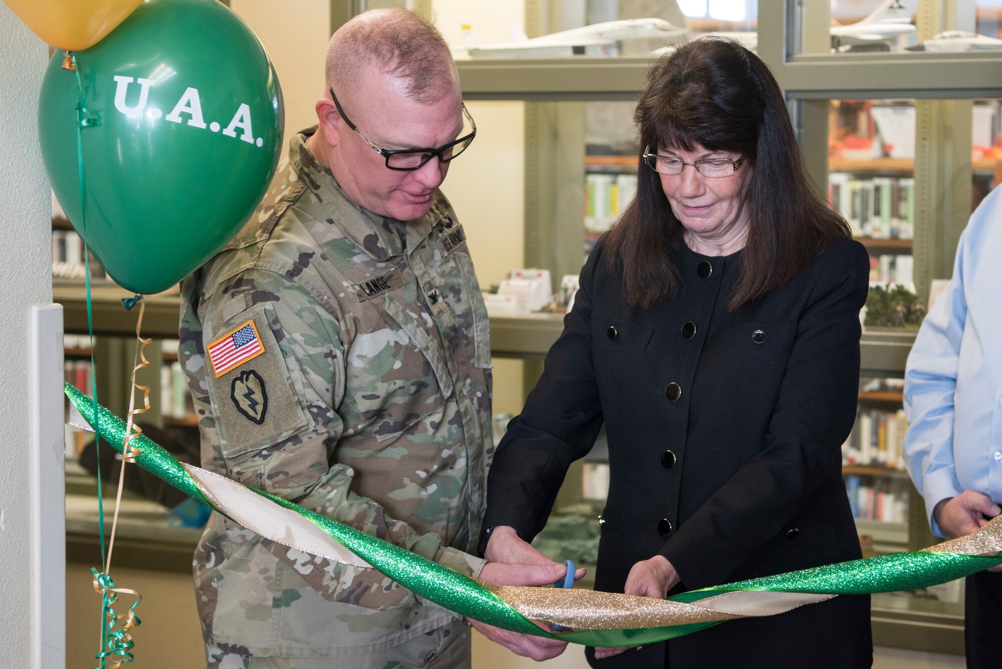 U.S. Army Col. Adam Lange, 673d Air Base Wing vice commander, and Renee Carter-Chapman, University of Alaska Anchorage (UAA) senior vice provost, cut the ribbon during a ceremony at the Joint Base Elmendorf-Richardson Education Center Nov. 2, 2018. The ceremony marks the opening of the academic tutoring room sponsored by the UAA. This room is open to all active-duty personnel, dependents and veterans, no matter which school they attend.