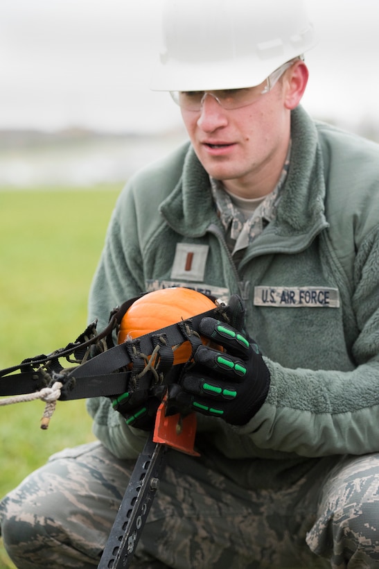 2nd Lt. Joshua Lightner, Air Force Life Cycle Management Center’s F-15 Engineering Branch, loads a pumpkin into a trebuchet-style catapult Nov. 2 in preparation for the 14th annual Wright-Patterson Air Force Base, Ohio, pumpkin chuck.
