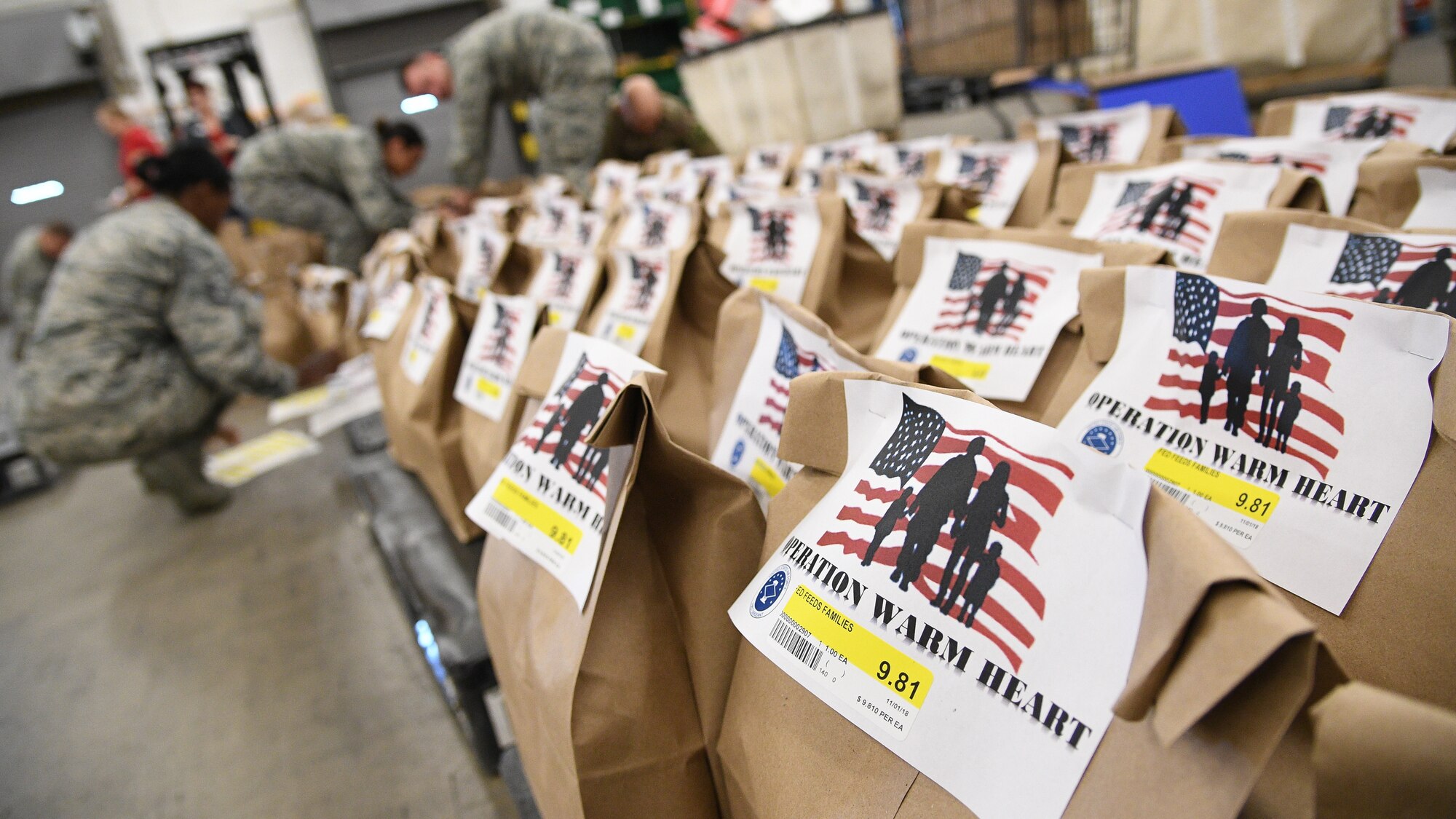 Hill's First Sergeant Council and the base commissary packaged 200 Operation Warm Heart Thanksgiving bags on Nov. 2, 2018, at Hill Air Force Base, Utah. The bags, filled with side dishes, along with a turkey and pie, donated by commissary vendors, will be deliver to Airmen to assist with the upcoming holiday. (U.S. Air Force photo by R. Nial Bradshaw)