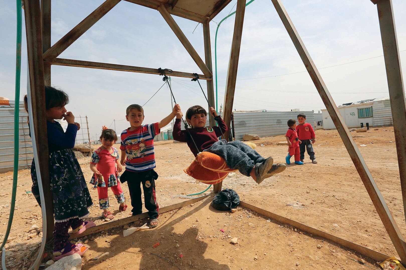 United Nations Photo: Zaatari Refugee Camp, Jordan. From < https://www.flickr.com/photos/un_photo/33628939391/in/photolist-2a64bte-28GYMmp-VCy7hg-VQ2Vbv-VQ2Vai-VCy7dP-VQ2V8K-VCy7fH-VeMotq-SR6t3d-TeF74R-PGYtjG-HKHnQi-JCTiNC-Fw6LcE-G2rSum-FwhcDR-Gip8jU-GkHFA8-GrymiX-FR748F-FGW5tG-EVRf8x-FGW5iS-Dt1Upf-pKPPMx-ptnYrC-dWGdNT-8B4nDo-6R1KQH-6R5Nxf-6R5Nwy-6R1KNT-6R1KPp-6R1KNr-6R1KLM-6R1KLr-6R1KKp-6R5NrE-6R5NqE-6R1KK4-72kEss-6pmvEr-63srmZ>. Licensed under Creative Commons Attribution 2.0 Generic License. Photo unaltered.