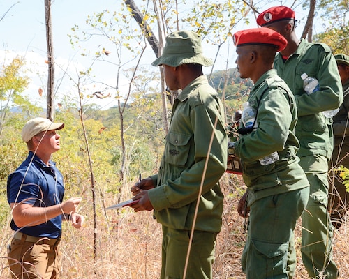 In July, U.S. soldier assigned to the Combined Joint Task Force—Horn of Africa provides guidance for Tanzania Wildlife Management Authority game wardens during a ground surveillance exercise in Tanzania