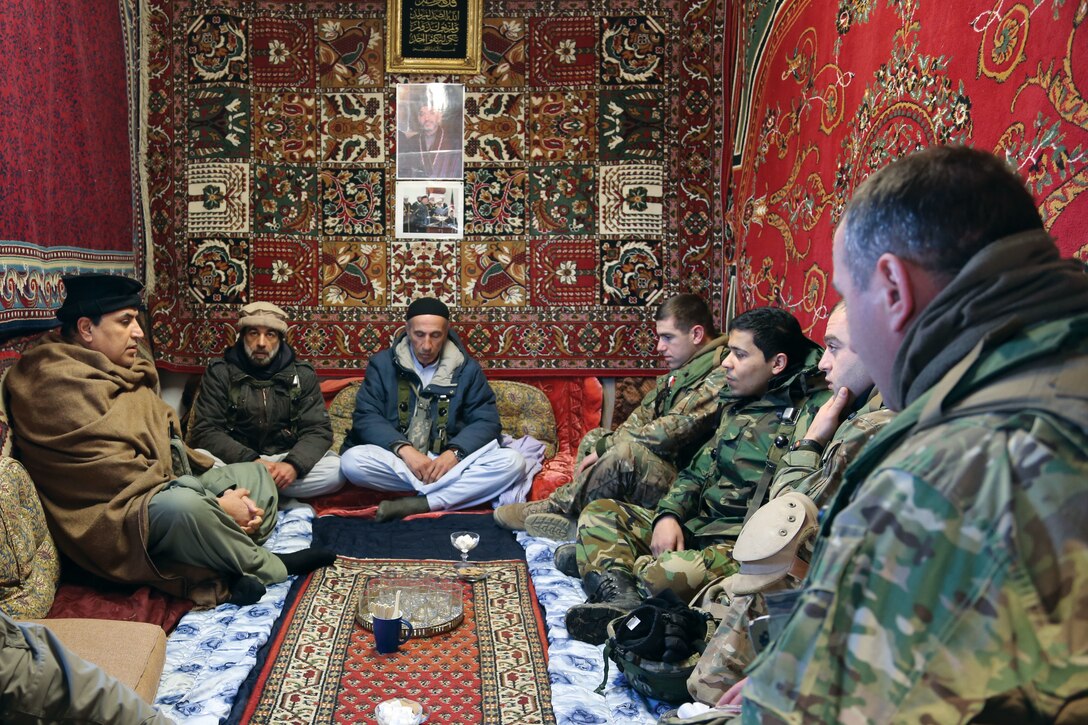 In 2014, Georgian and U.S. soldiers conduct a key leader engagement with village elders, role-played by civilians during a mission rehearsal exercise at the Joint Multinational Readiness Center in Germany. The combined training exercise prepares soldiers on counterinsurgency, stability, and transportation operations for a deployment to Afghanistan in support of NATO. (DOD/ Justin DeHoyas)