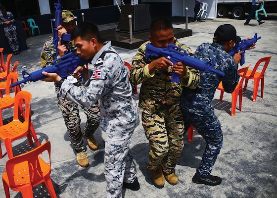 In August, a Royal Thai Coast Guardsman (left), A Philippine sailor (center), and a Philippine Coast Guardsman practice tactical visit, search, and seizure procedures during the Southeast Asia Cooperation and Training (SEACAT) exercise that included participants from nine partner nations. SEACAT began in 2002 under the name “Southeast Asia Cooperation Against Terrorism” but was renamed in 2012 to expand the scope of training among regional navies and coast guards. (DOD/Micah Blechner)