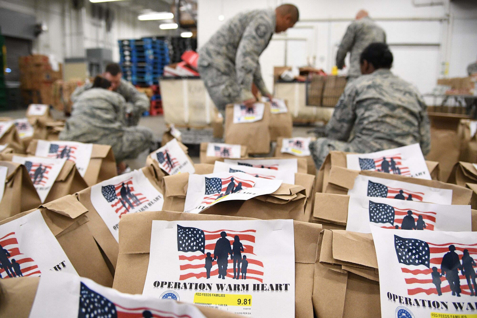Hill's First Sergeant Council and the base commissary packaged 200 Operation Warm Heart Thanksgiving bags on Nov. 2, 2018, at Hill Air Force Base, Utah. The bags, filled with side dishes, along with a turkey and pie, donated by commissary vendors, will be deliver to Airmen to assist with the upcoming holiday. (U.S. Air Force photo by R. Nial Bradshaw)