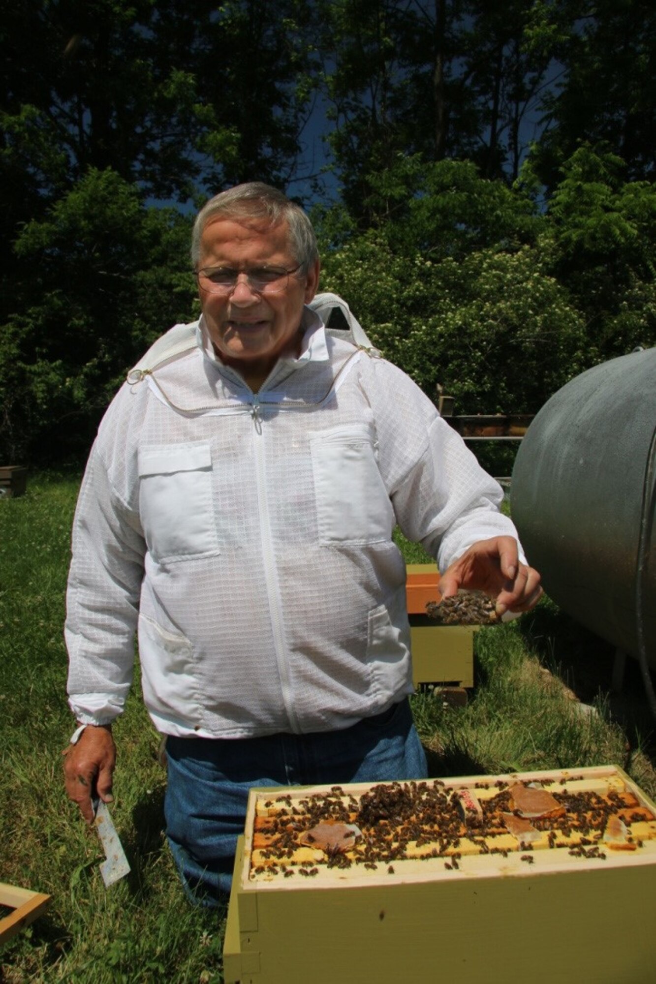 Dwight Wells, a beekeeper with the Propolis project, works with Instrumented Queen honey bees at Purdue University. Instrumental Insemination of Queen honey bees, animals or humans is artificial insemination instead of natural mating (Courtesy photo)