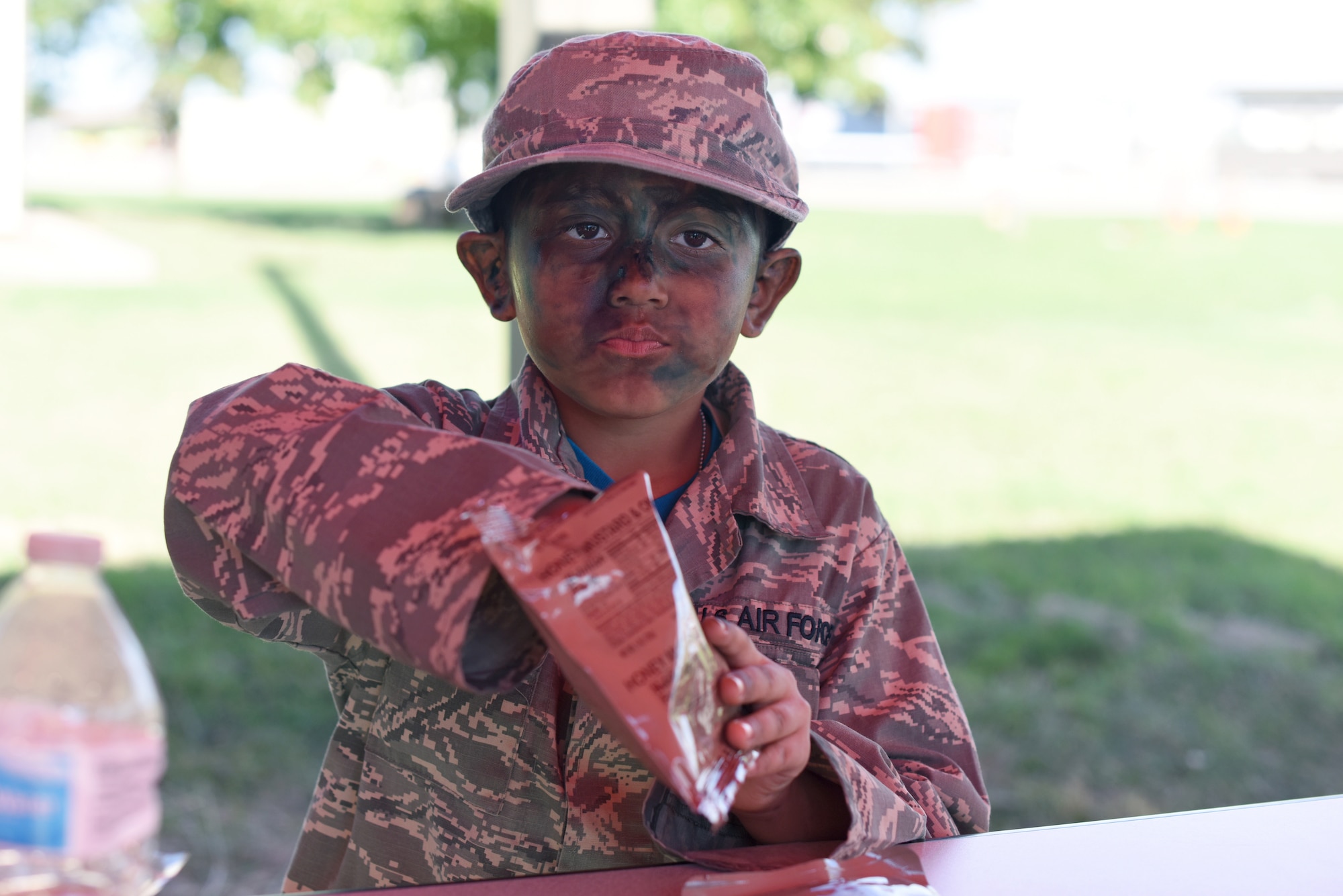 Art, an Operation KIDS participant, eats a Meal, Ready-to-Eat during lunch at the Louis F. Garland Department of Defense Fire Academy Goodfellow Air Force Base, Texas, Nov. 3, 2018. Art is a veteran, having participated in three Operation KIDS at Goodfellow and this year talked about how exciting it was being able to share the experience with his cousin. (U.S. Air Force photo by Airman 1st Class Seraiah Hines/Released)