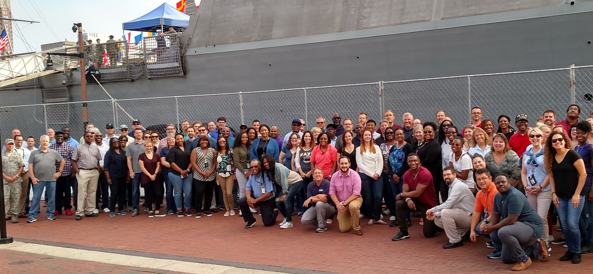 Group of people standing in front of a ship