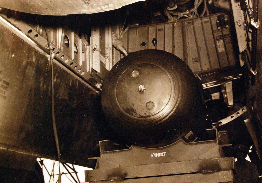 Atomic bomb “Little Boy” hoisted into bomb bay of B-29 Superfortress, Enola Gay, Tinian Island, August 1945 (U.S. Navy National Museum)