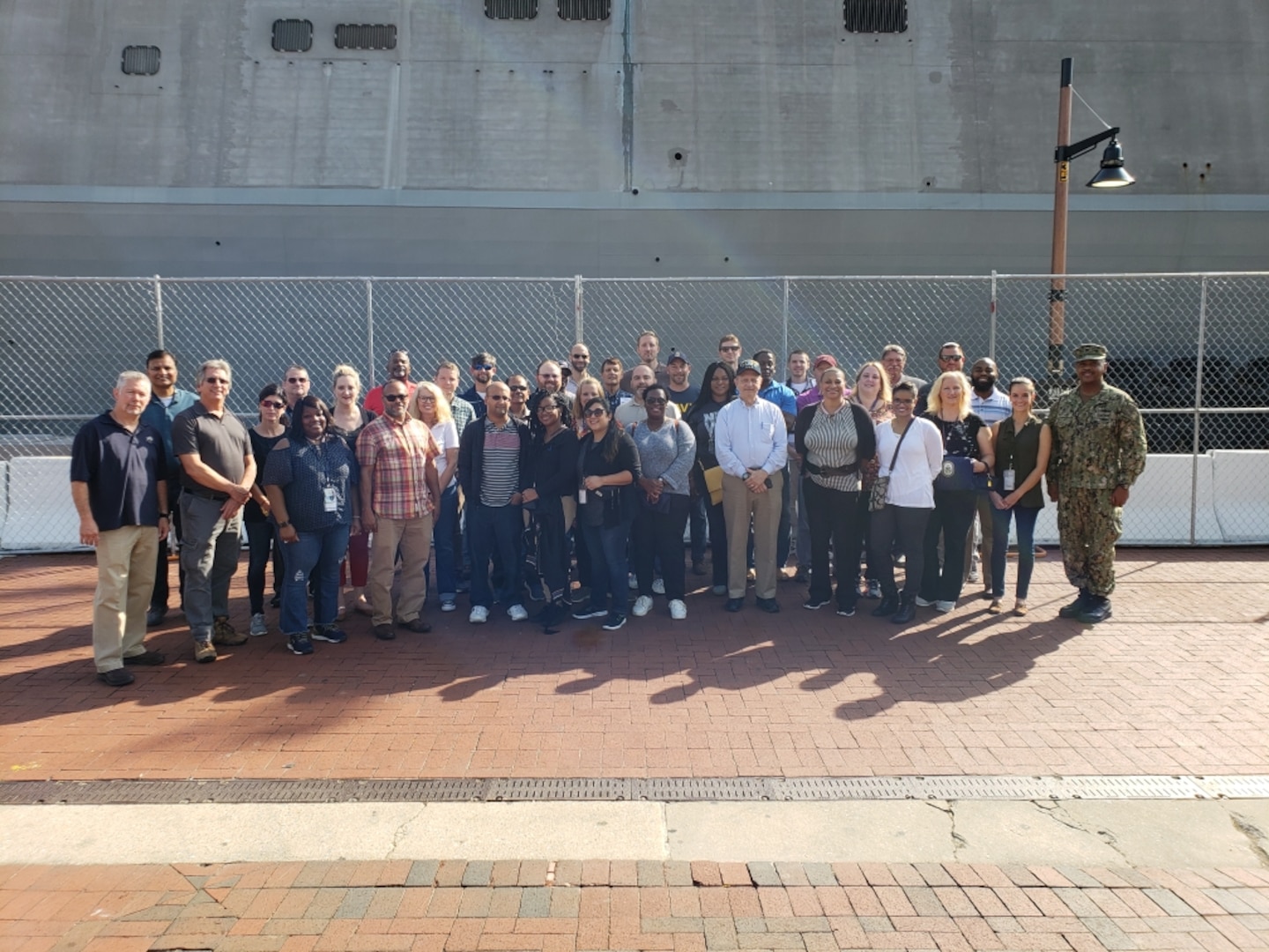 Group of people standing in front of a ship