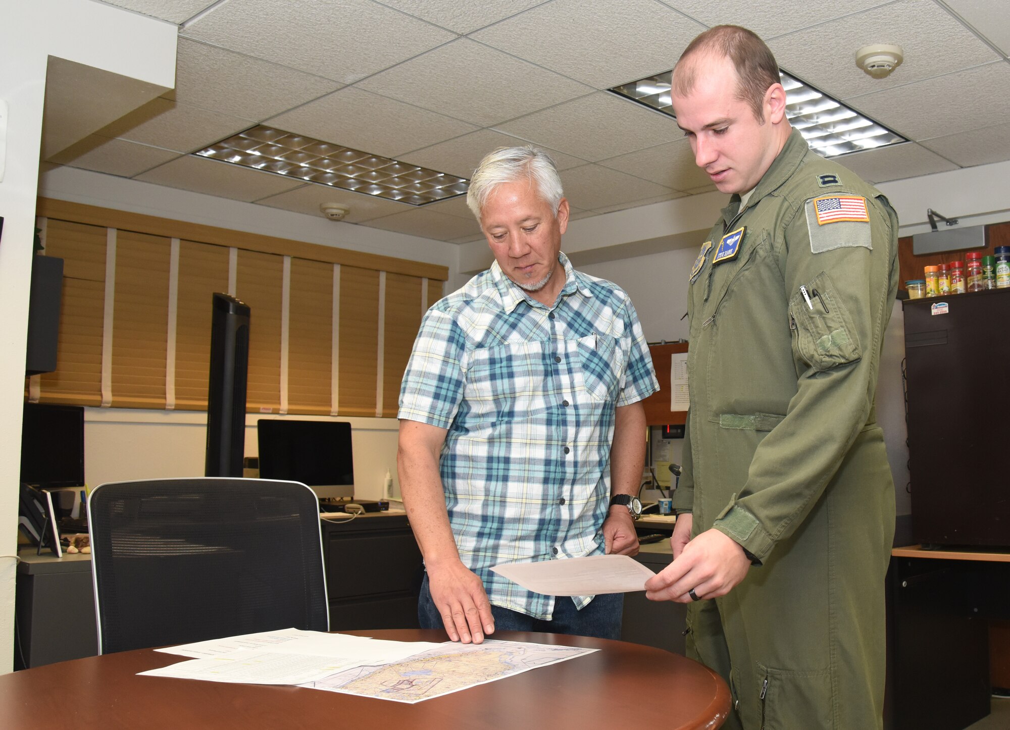 Flight planner goes over mission with pilot.