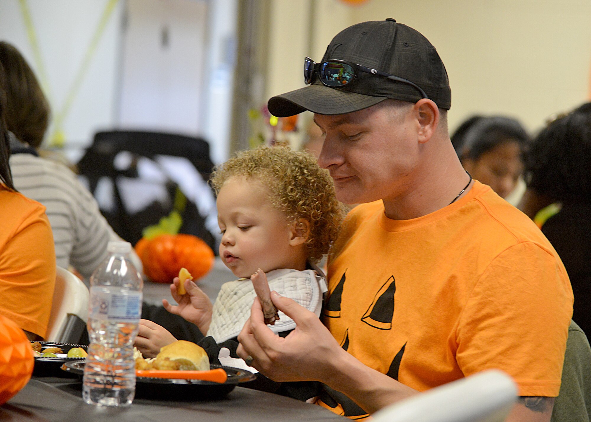 Staff Sgt. Kyle Johnson from 58th Aircraft Maintenance Squadron eats with his son Kaidyn, 2, at a special Halloween Kirtland Playgroup here Oct. 30, 2018. The weekly playgroup is sponsored by Kirtland Family Advocacy and meets every Tuesday from 10:30 a.m. to noon in the Chapel Annex. The group provides unstructured play time for infants, toddlers and their parents. (U.S. Air Force photo by Todd Berenger)