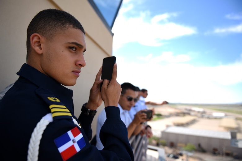 Gean Louis Torres Herrera, Dominican Air Force cadet and class leader, takes photos of the view from the balcony of the air traffic control tower Oct. 31, 2018, at Luke Air Force Base, Ariz. Torres Herrera is one of a group of the top two cadets from each of various Latin American air service academies from countries including Mexico, Brazil, and Colombia, who are touring U.S. bases as a part of the Department of Defense Latin American Cadet Initiative. (U.S. Air Force photo by Senior Airman Ridge Shan)