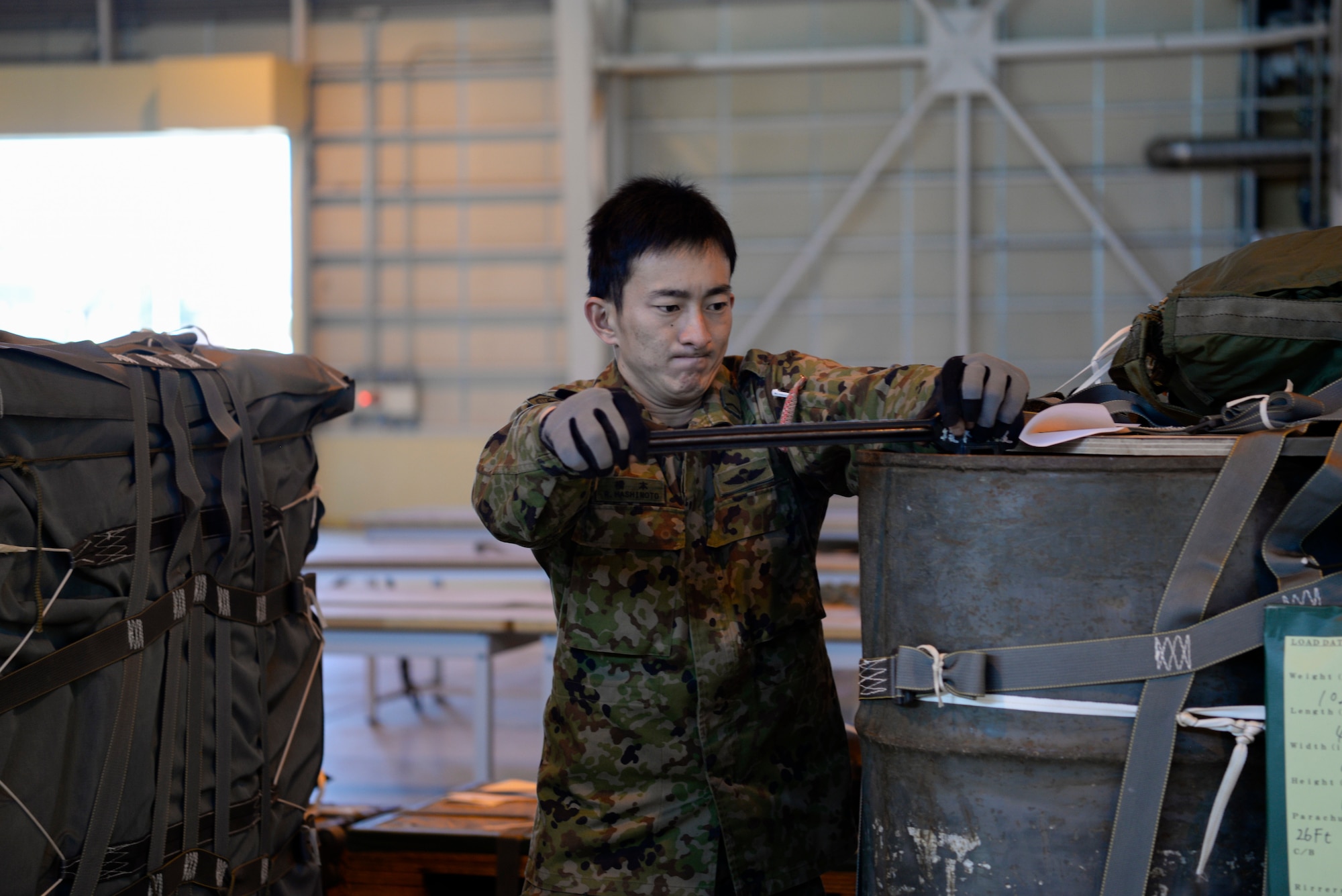 A Japan Ground Self-Defense Force soldier assigned to the 1st Airborne Brigade performs supply bundle checks, at Yokota Air Base, Japan, Nov. 2, 2018, during Keen Sword 19.