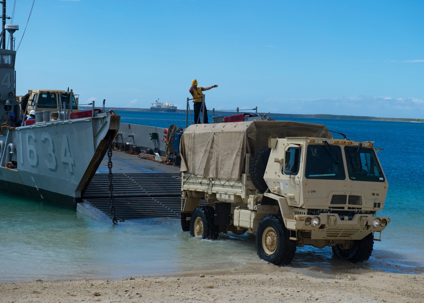 SANTA RITA, Guam (Nov. 06, 2018) Sailors assigned to Landing Craft Utility (LCU) 1634, attached to Naval Beach Unit (NBU) 7 forward-deployed to Sasebo, Japan, embarked aboard amphibious dock landing ship USS Ashland (LSD 48), direct a Solider assigned to the Guam Army National Guard as he drives to pick up supplies for Super Typhoon Yutu recovery effort. Service Members from Joint Region Marianas and U.S. Indo-Pacific Commands are providing Department of Defense support to the Commonwealth of the Northern Mariana Islands civil and local officials as part of the FEMA-supported Super Typhoon Yutu recovery effort.