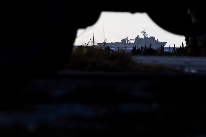 The dock landing ship USS Ashland sits idle off the coast during the U.S. Defense Support of Civil Authorities relief effort in response to Super Typhoon Yutu, Tinian, Commonwealth of the Northern Mariana Islands, Nov. 3, 2018. Businesses, government buildings, homes and schools were heavily damaged by Super Typhoon Yutu, which made a direct hit with devastating effect on Tinian Oct. 25 packing 170 MPH winds – it is the second strongest storm to ever hit U.S. soil and the strongest storm of 2018. Marines with the 31st Marine Expeditionary Unit and CLB-31 have been leading a multi-service contingent since Oct. 29 as part of the U.S. Federal Emergency Management Agency-directed DSCA mission here. The Ashland arrived today to deliver a larger contingent of Marines and Seabees to further assist the people of Tinian. The Marines arrived at the request of CNMI officials and FEMA to assist relief efforts in the wake of Yutu, the largest typhoon to ever hit a U.S. territory. The 31st MEU, the Marine Corps’ only continuously forward-deployed MEU, provides a flexible force ready to perform a wide-range of military operations across the Indo-Pacific region.