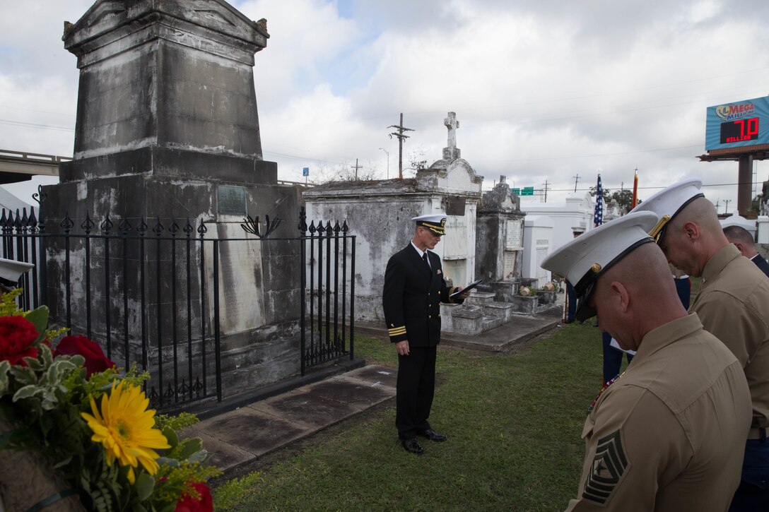Commander Ronald Newhouse, the religious enrichment development chaplain with Marine Forces Reserve, gives the invocation at the gravesite of Marine Corps Maj. Daniel Carmick during a wreath laying ceremony at St. Louis Cemetery No. 2 in New Orleans, Nov. 6, 2018. This ceremony is held annually to celebrate and honor the legacy and actions of Maj. Carmick during the Battle of New Orleans during the War of 1812. Maj. Carmick’s leadership on the battlefield was an essential contribution that resulted in the defeat of British troops and prevented the seizure and conquest of the Louisiana territory. (U.S. Marine Corps photo by Lance Cpl. Samantha Schwoch/released)
