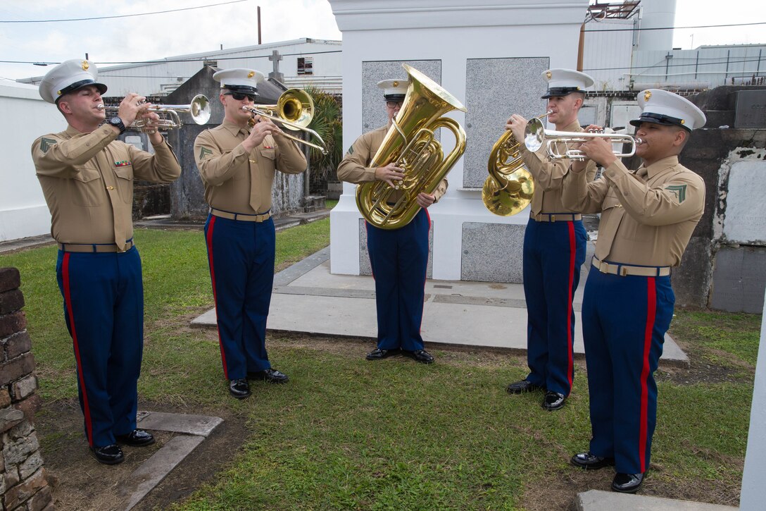 Marines with the Marine Forces Reserve band play the national anthem at a wreath laying ceremony for Marine Corps Maj. Daniel Carmick, at St. Louis Cemetery No. 2 in New Orleans, Nov. 6, 2018. This ceremony is held annually to celebrate and honor the legacy and actions of Maj. Carmick during the Battle of New Orleans during the War of 1812. Maj. Carmick’s leadership on the battlefield was an essential contribution that resulted in the defeat of British troops and prevented the seizure and conquest of the Louisiana territory. (U.S. Marine Corps photo by Lance Cpl. Samantha Schwoch/released)