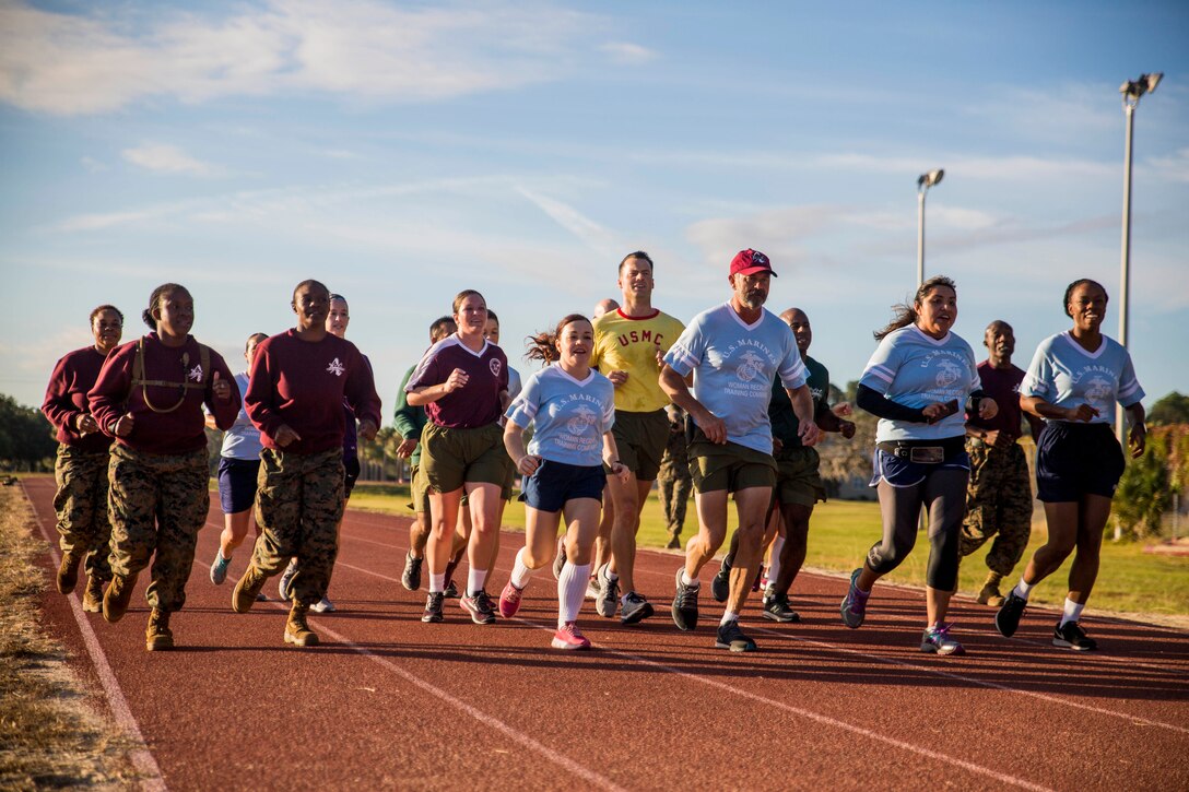 Marines, sailors and civilians conduct a timed run during a field meet celebrating the 32nd anniversary of 4th Battalion at Marine Corps Recruit Depot Parris Island, South Carolina, November 4, 2018. The field meet consists of the various physical fitness standards female Marines have had to pass throughout the 100 years females have been allowed to enlist into the Marine Corps. (U.S. Marine Corps photo by Cpl. Vivien Alstad)