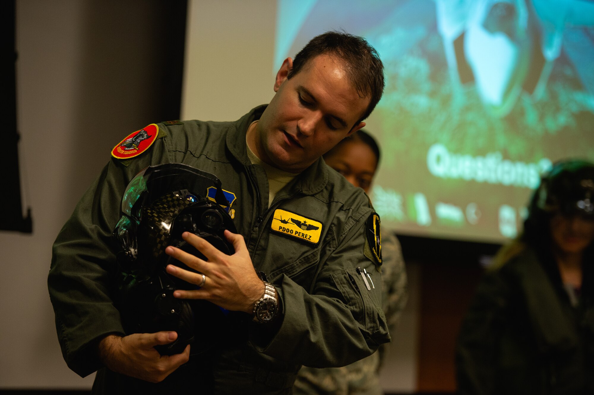 Maj. Fernando Perez, 61st Fighter Squadron, director of weapons, briefs members of the Personalized Learning Cohort about an F-35A Lightning II helmet during a visit to Luke Air Force Base, Ariz., Nov. 2, 2018. Throughout the tour, members of the cohort were given the opportunity to speak with Airmen and receive a comprehensive review of some of the resources and tools used to train fighter pilots. (U.S. Air Force photo by Senior Airman Alexander Cook)