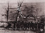 After this gun section of Battery D, 105th Field Artillery Regiment, New York National Guard, had fired its last shot at Etraye, the men raised Old Glory amid triumphant shouts on Armistice Day, Nov. 11, 1918.