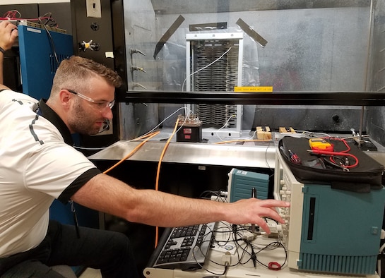 Air Force Research Laboratory electrical engineer Corey Boltz makes final adjustments before conducting a proof-of-concept arc test in preparation for follow-up testing to support a NASA research effort. (U.S. Air Force Photo/Holly Jordan)