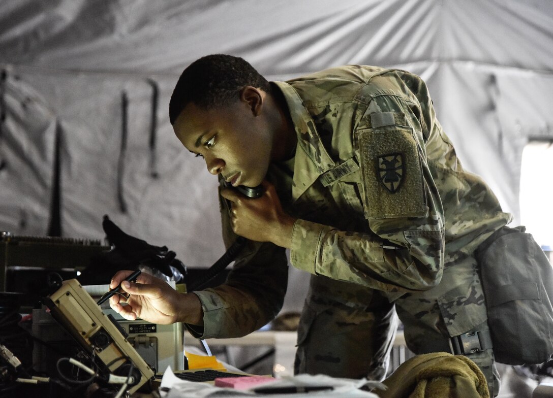 U.S. Army Spc. Ali Armstrong, 331st Transportation Company, 11th Trans. Battalion, 7th Trans. Brigade (Expeditionary) communication specialist, sends a situational report to the battalion Tactical Operation Center at Fort Pickett, Virginia, Oct. 23, 2018.