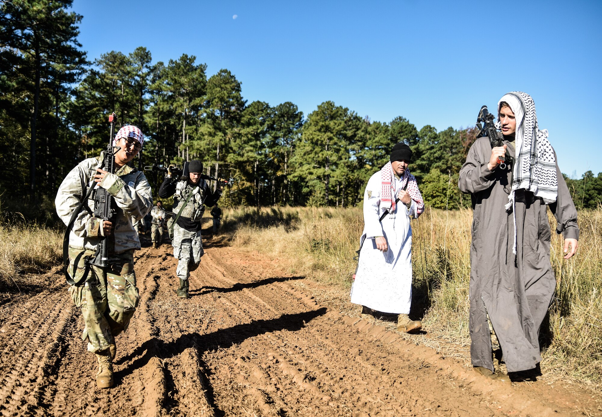 U.S. Army Soldiers assigned to the 1098th Transportation Detachment, 11th Trans. Battalion, 7th Trans. Brigade (Expeditionary), dress in opposition force clothing and prepare to simulate an attack on a neighboring unit at Fort Pickett, Virginia. Oct. 29, 2018.