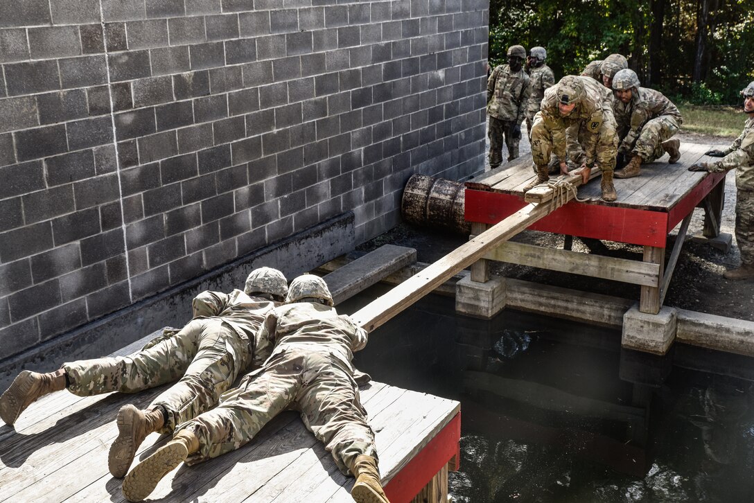 U.S. Army Soldiers assigned to the 11th Transportation Battalion, 7th Trans. Brigade (Expeditionary), work through a Leaders Reaction Course at Fort Pickett, Virginia, Oct. 29, 2018.