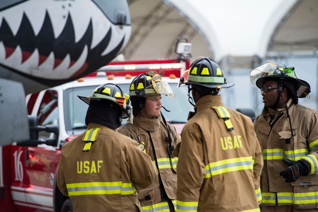 Firefighters from the 23d Civil Engineer Squadron discuss tactics, techniques and procedures during an A-10C Thunderbolt II egress exercise, Nov. 5, 2018, at Moody Air Force Base, Ga. The five-day exercise, scheduled to take place Nov. 5-9, will give base personnel an opportunity to experience contingency operations in a contested and degraded combat environment. (U.S. Air Force photo by Senior Airman Janiqua P. Robinson)