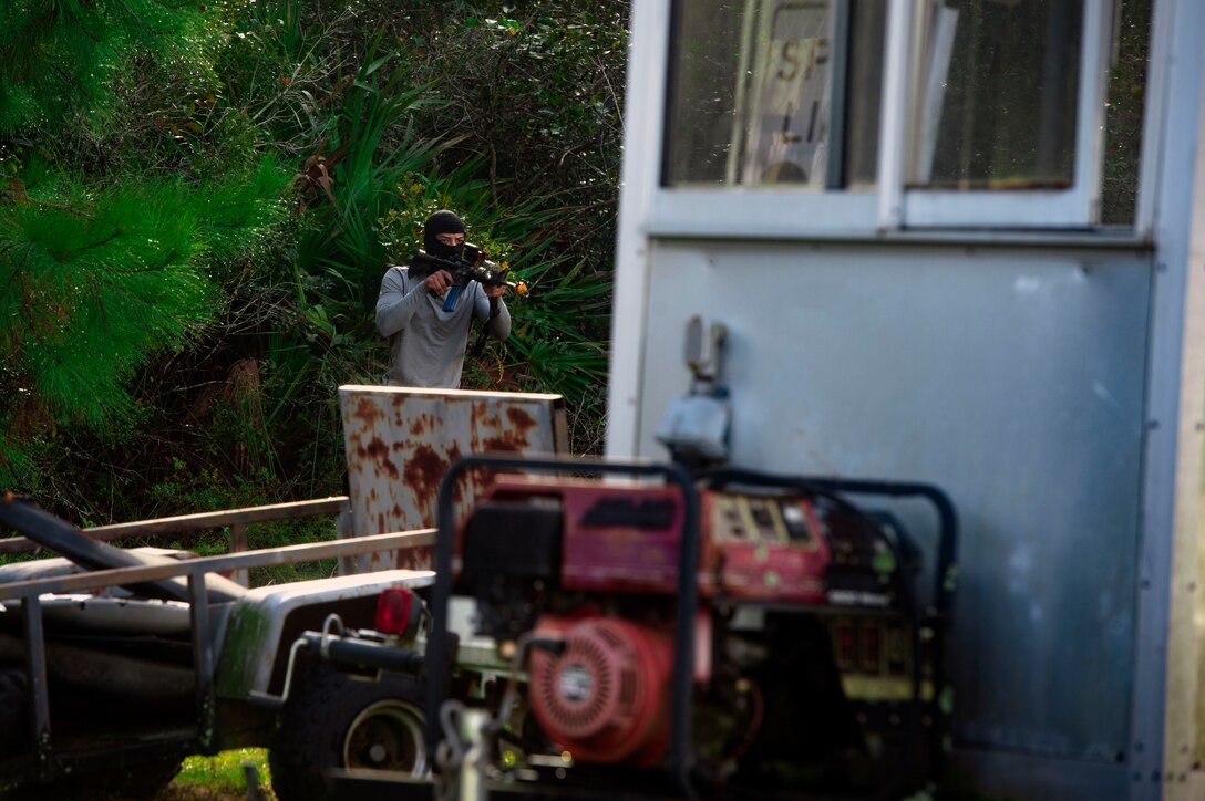 A mock insurgent battles the 23d Security Forces Squadron during exercise Flying Tigers 19-01C, Nov. 6, 2018, at Moody Air Force Base, Ga. The weeklong event is the second phase of a contingency operation exercise which tests Moody Airmen on their ability to successfully survive in a contested and degraded operational environment while donning mission-oriented protective posture (MOPP) gear. (U.S. Air Force photo by Senior Airman Greg Nash)